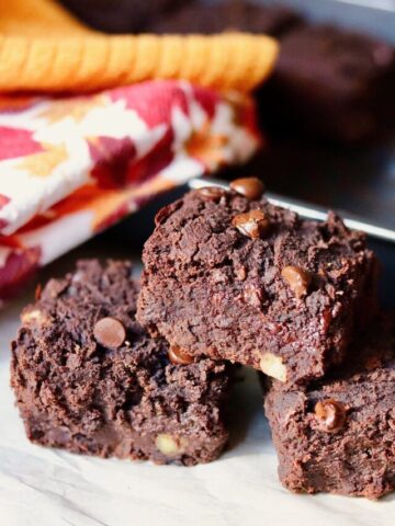 three black bean brownies on a plate