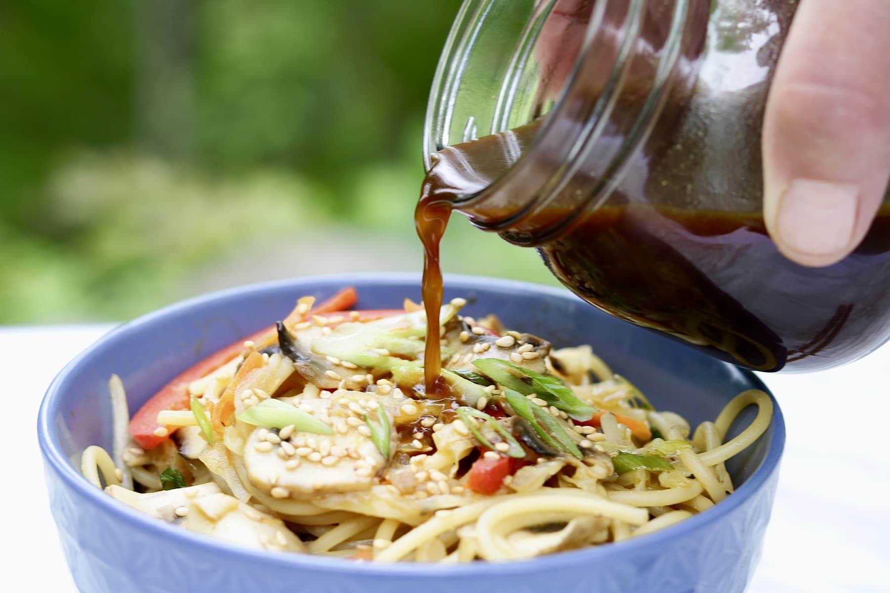 5 spice Stir-Fry sauce and noodles in blue bowl on marble countertop 