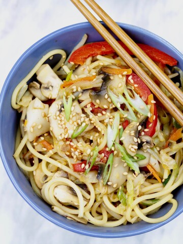 vegetable Chow Mein in blue bowl on marble countertop