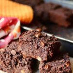 vegan black bean brownies cut into squares on a cutting board