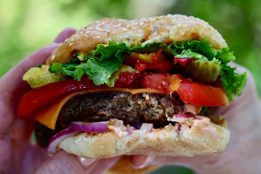 best vegan burger being held in the air