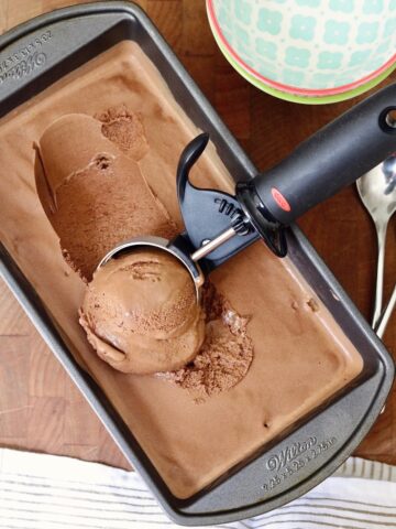 vegan chocolate ice cream being scooped from a container