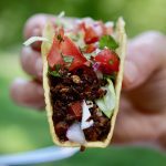 tasty tex mex vegan taco meat recipe held in the air