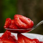 simple macerated strawberries recipe on a spoon