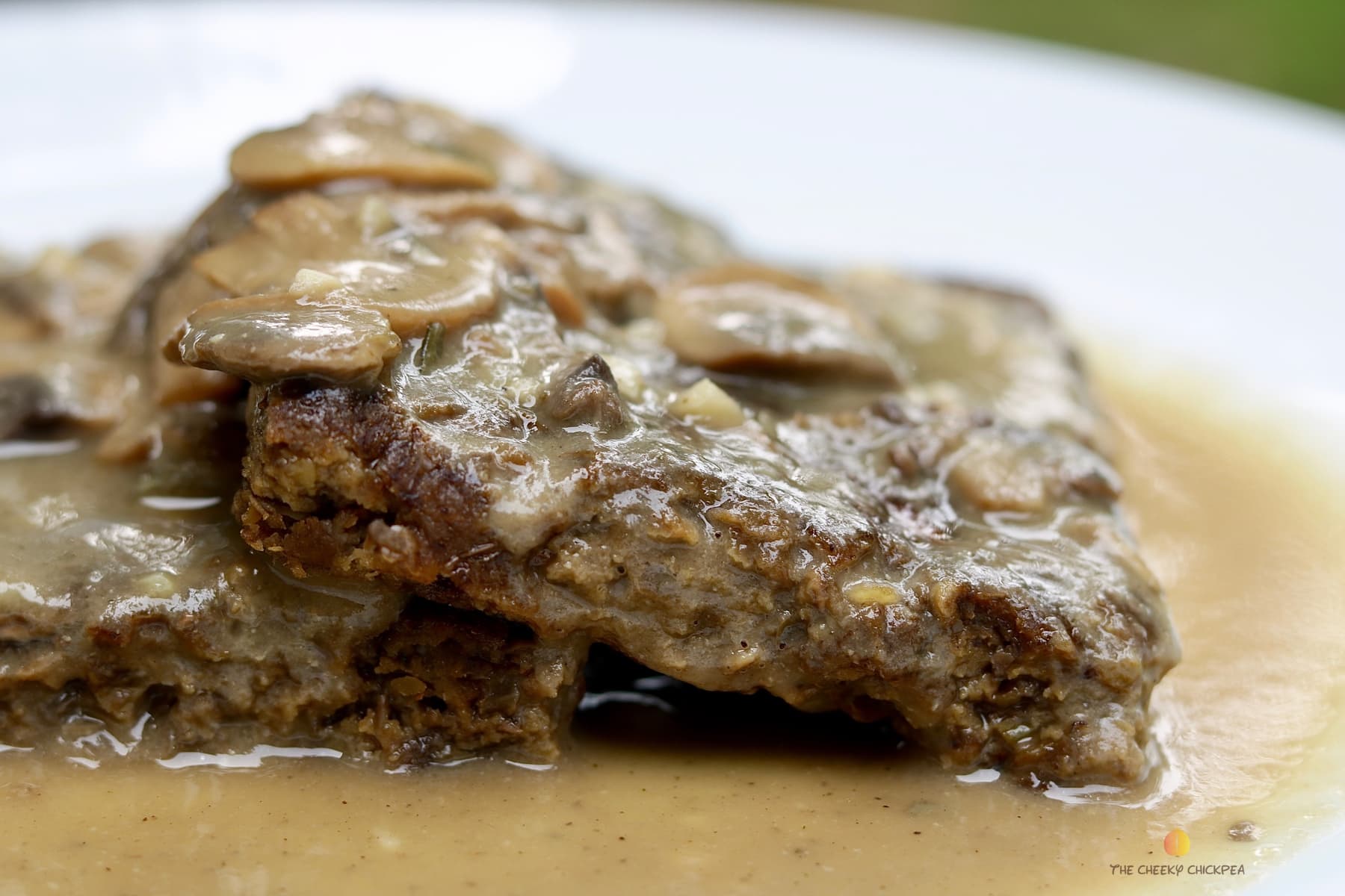 vegan salsbury steak meatloaf on a white plate