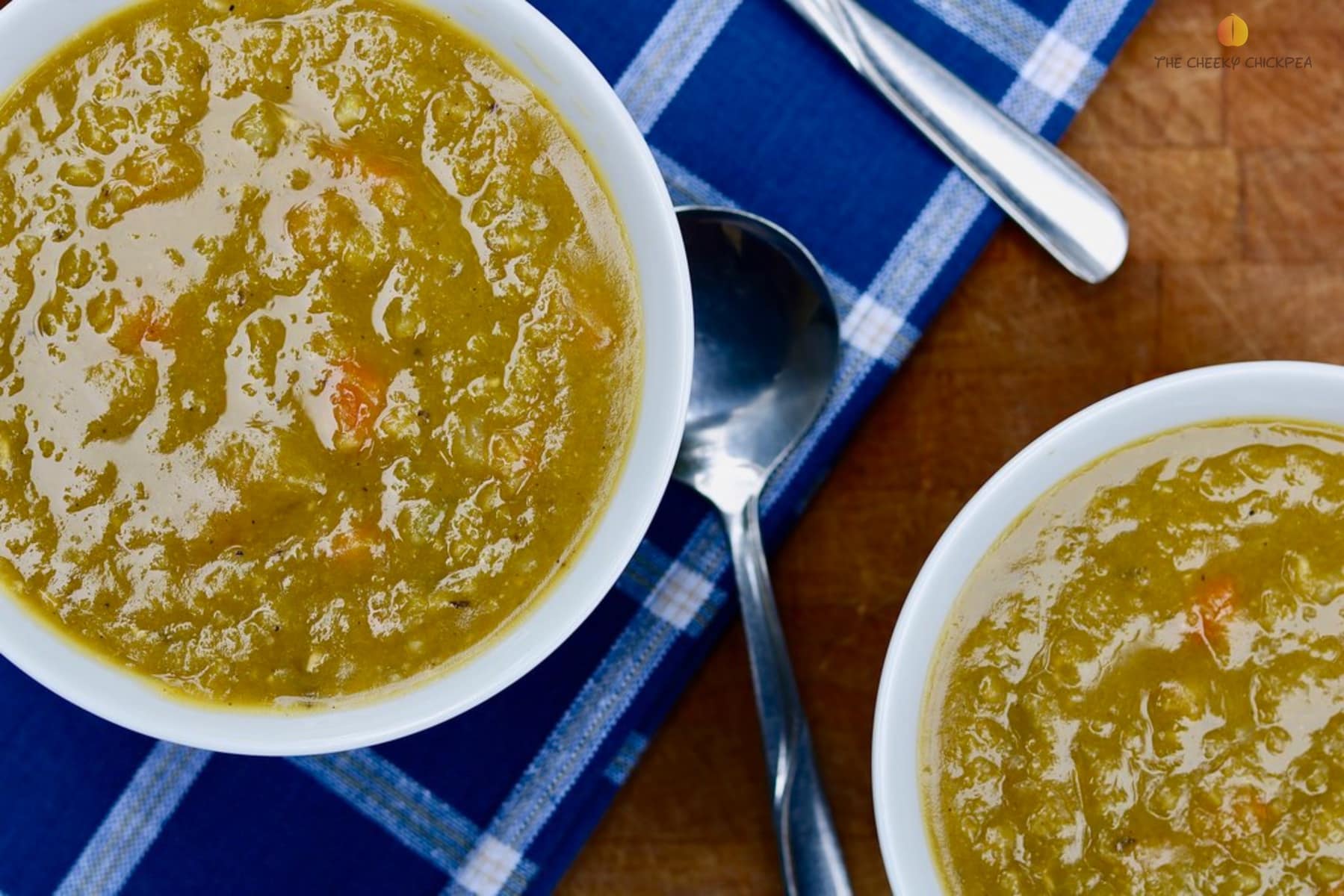 vegetarian split pea soup on a white bowl on wooden cutting board