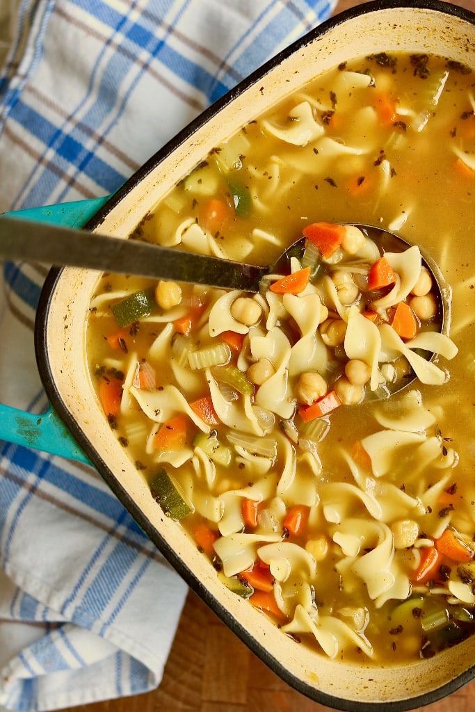 vegan chicken noodle soup in a pot with a ladle 