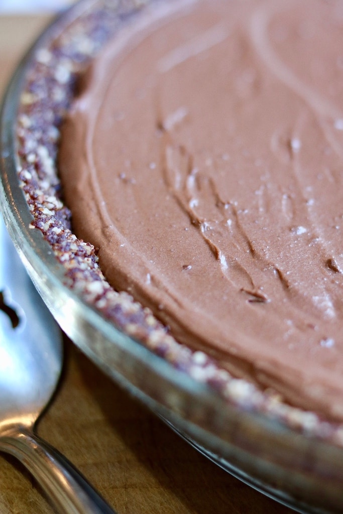 salted caramel vegan chocolate pie on a wooden cutting board