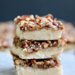 salted caramel & pecan vegan shortbread bars stacked on a counter