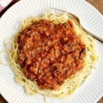 vegan bolognese sauce on a plate atop spaghetti