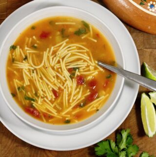 a bowl of sopa de Fideo Mexican noodle soup with a spoon