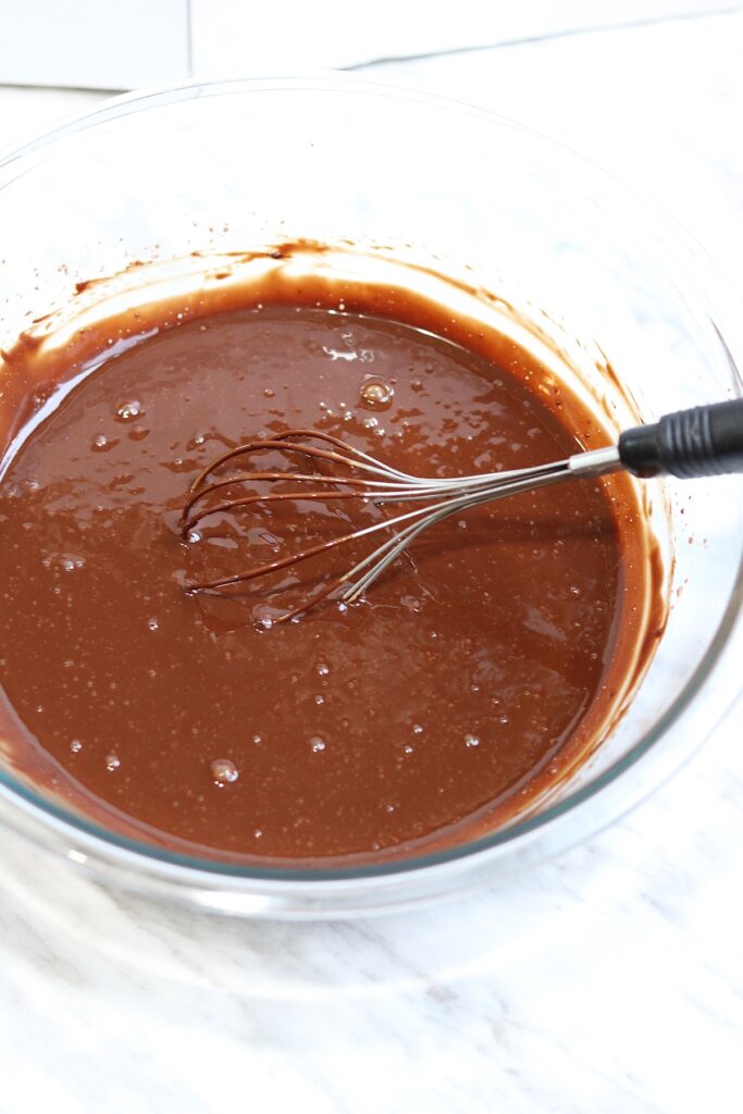 batter ingredients for vegan chocolate cake mixed in a bowl