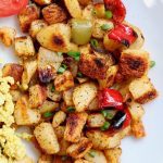 best home fries recipe on a white plate with peppers and onions mixed in