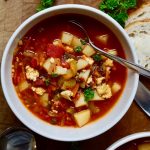 vegan hamburger soup in a white bowl on a wooden table