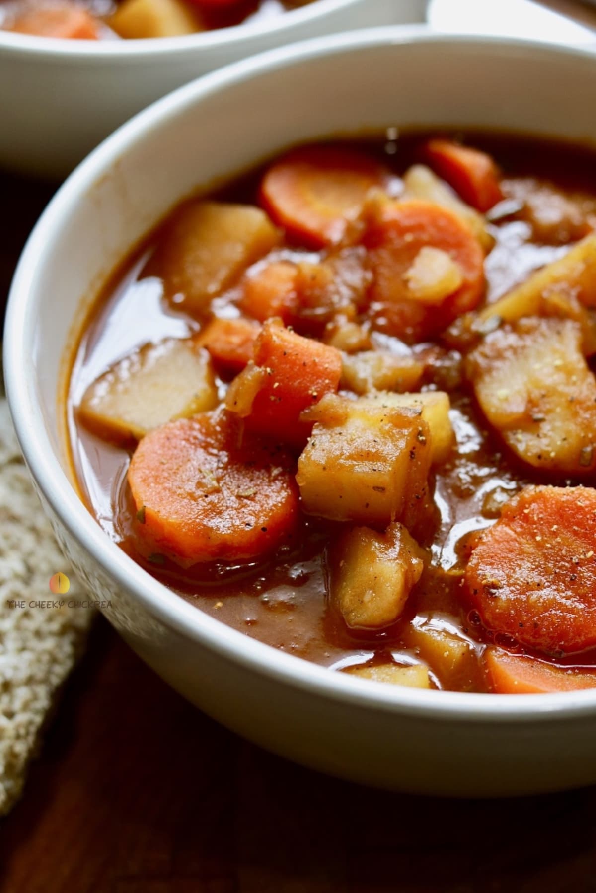 hearty vegan stew in a white bowl