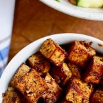 marinated tofu pieces in a white bowl