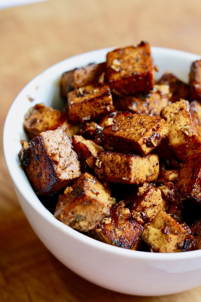 marinated tofu pieces in a white bowl