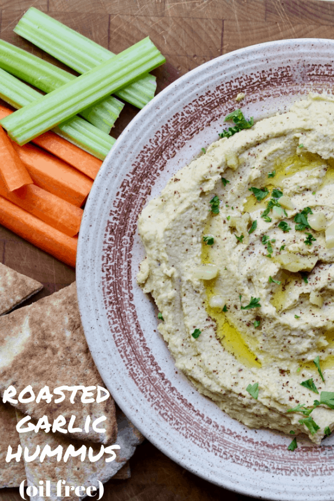 homemade hummus in a bowl along side pita and vegetables