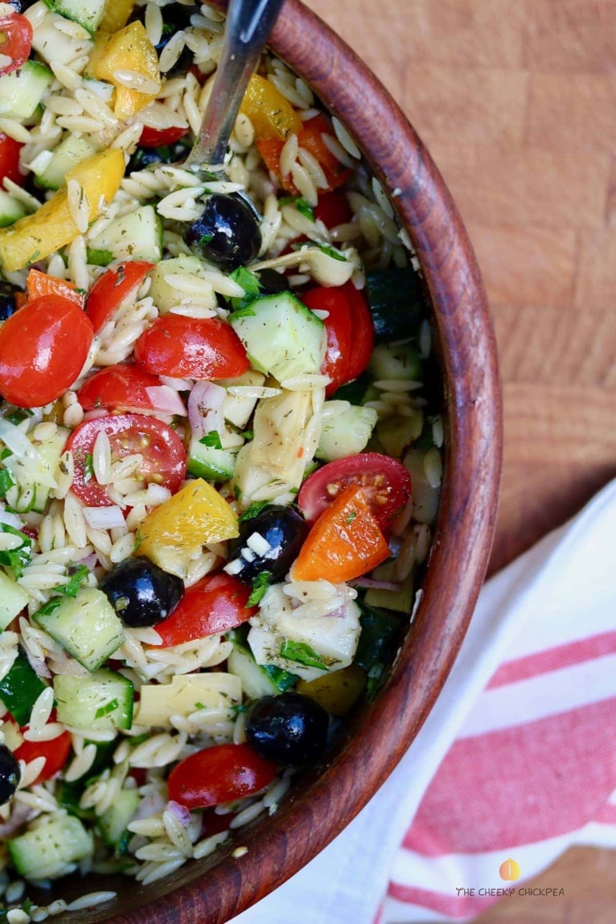 mediterranean orzo salad in a wooden bowl