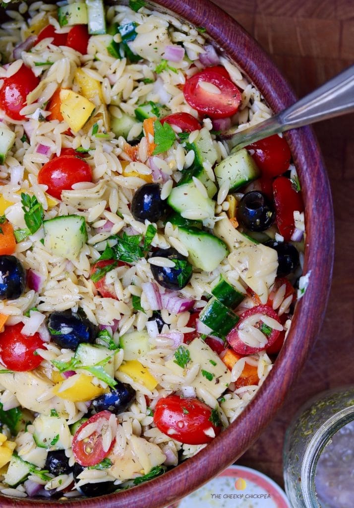 mediterranean orzo salad mixed in a wooden bowl