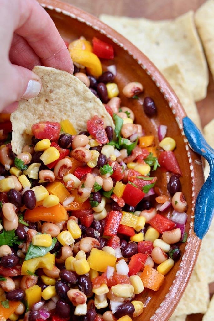 tortilla chip being dipped in cowboy caviar