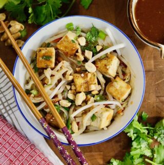 a bowl of vegan pad thai with tofu and veggies