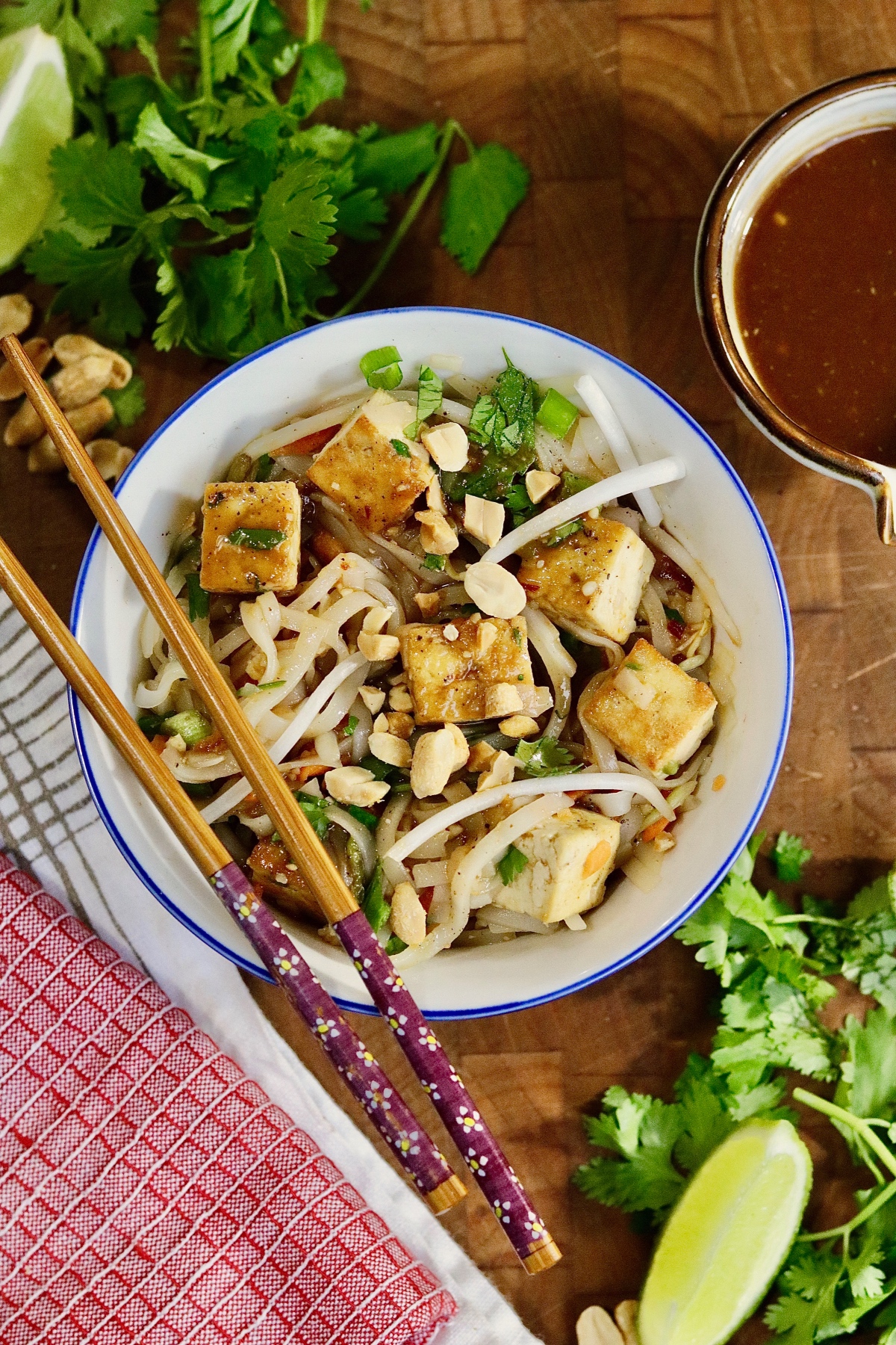 a bowl of vegan pad thai with tofu and veggies 