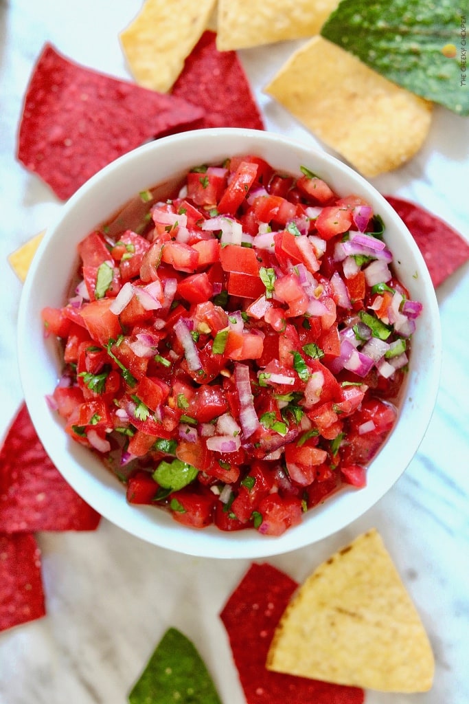 pico de Gallo in a white bowl surrounded by tortilla chips