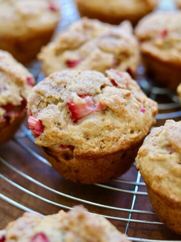 strawberry rhubarb muffins on a cooling rack