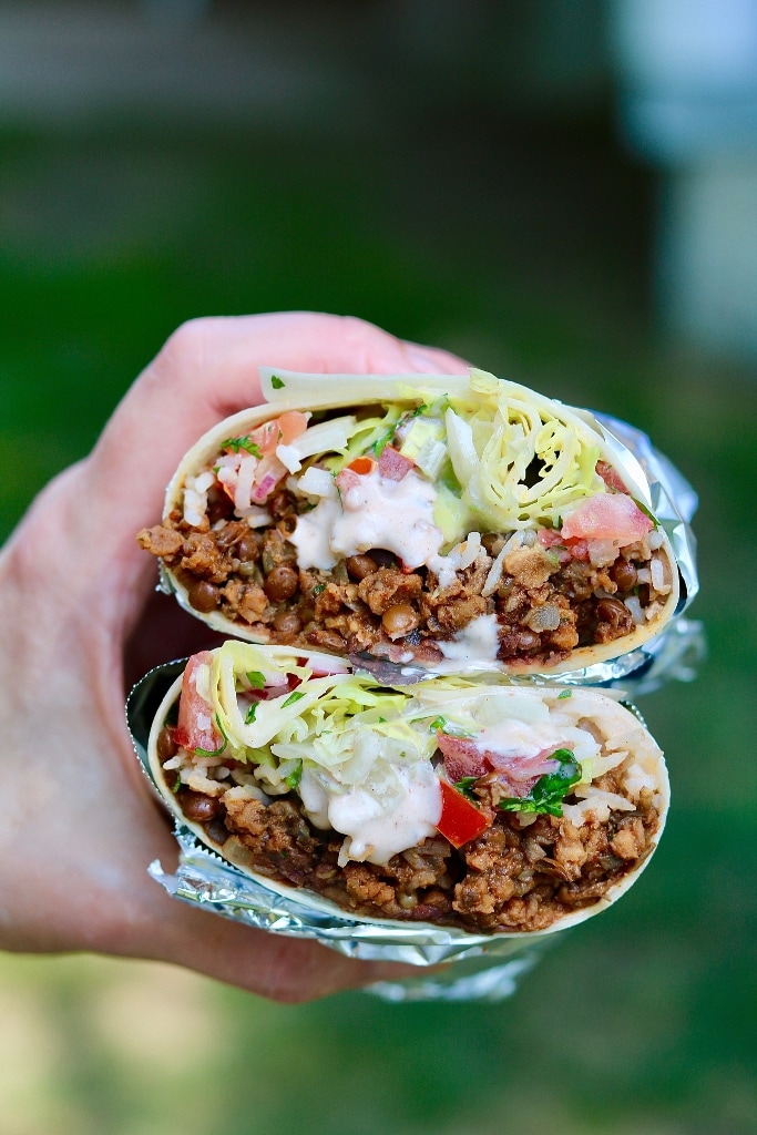 vegan burrito cut in half and wrapped in tin foil