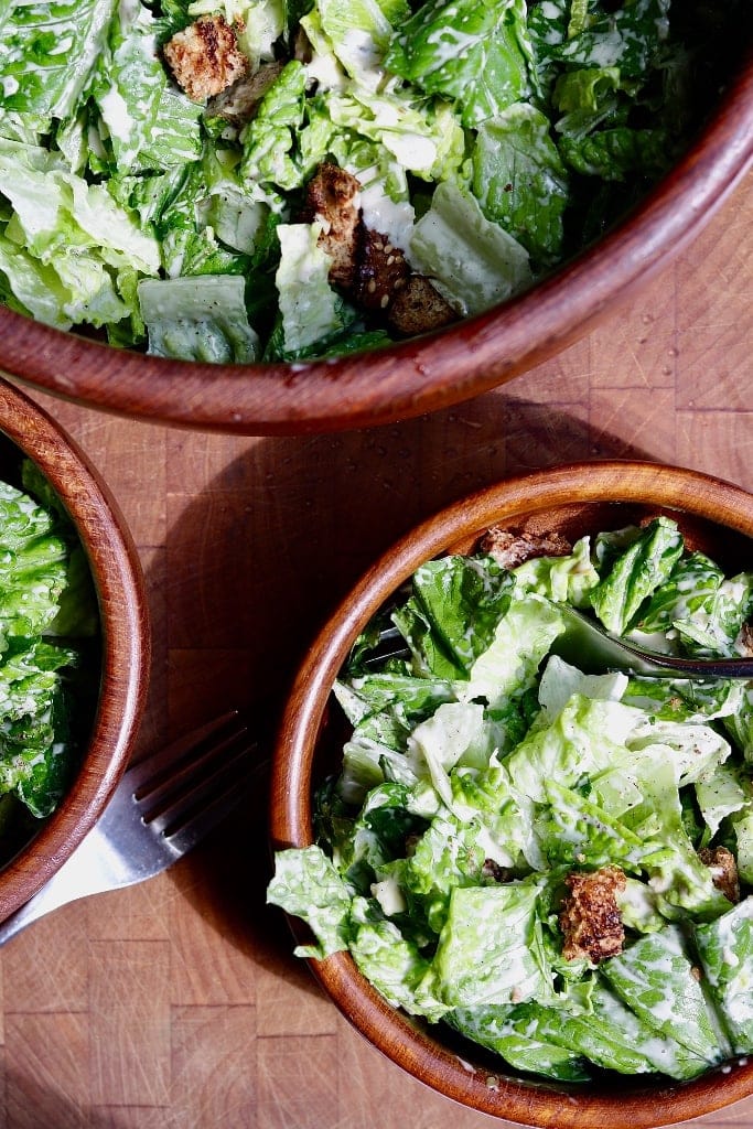 vegan caesar salad in three bowls