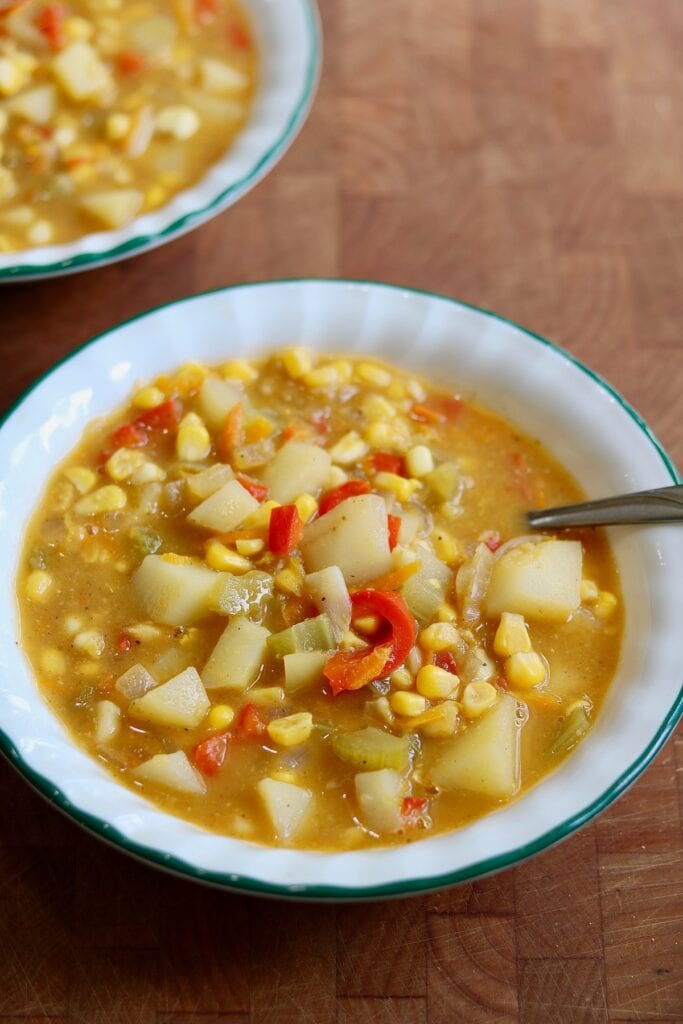 a bowl of vegan corn chowder with a spoon 