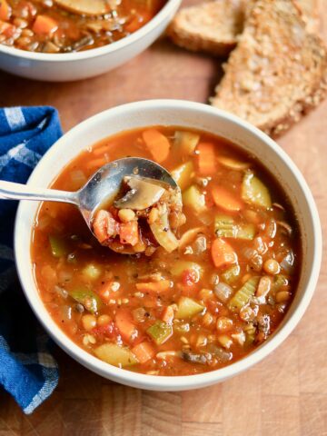 a bowl of italian lentil soup with a spoon