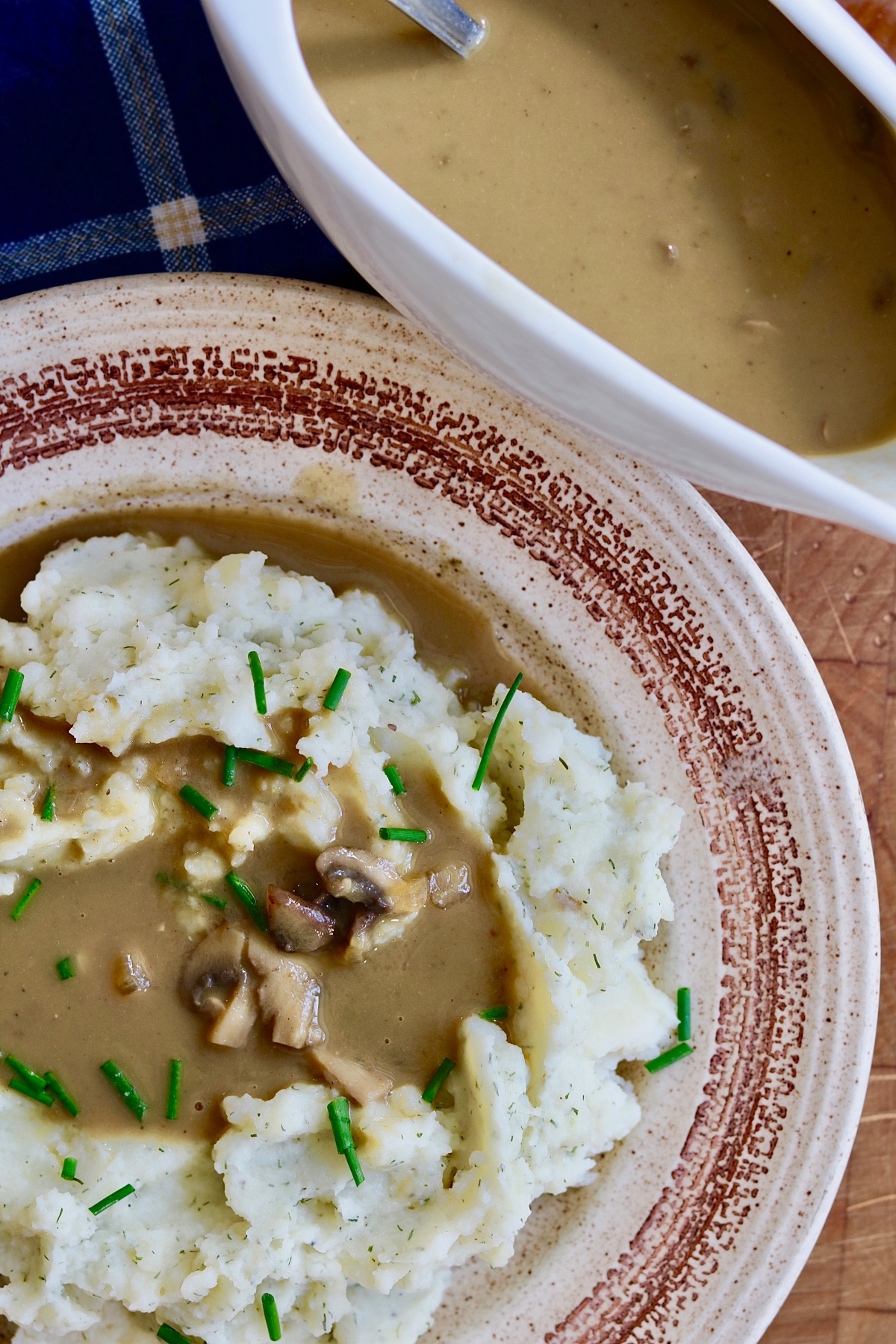 vegan mushroom gravy poured over a plate of mashed potatoes