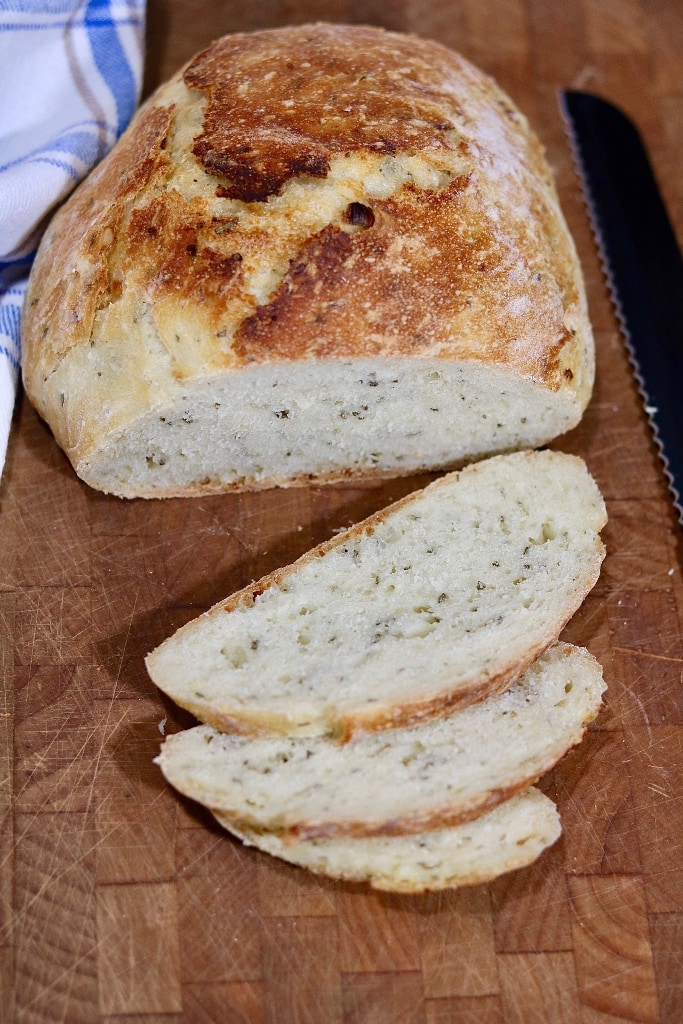 no knead artisan bread sliced on cutting board