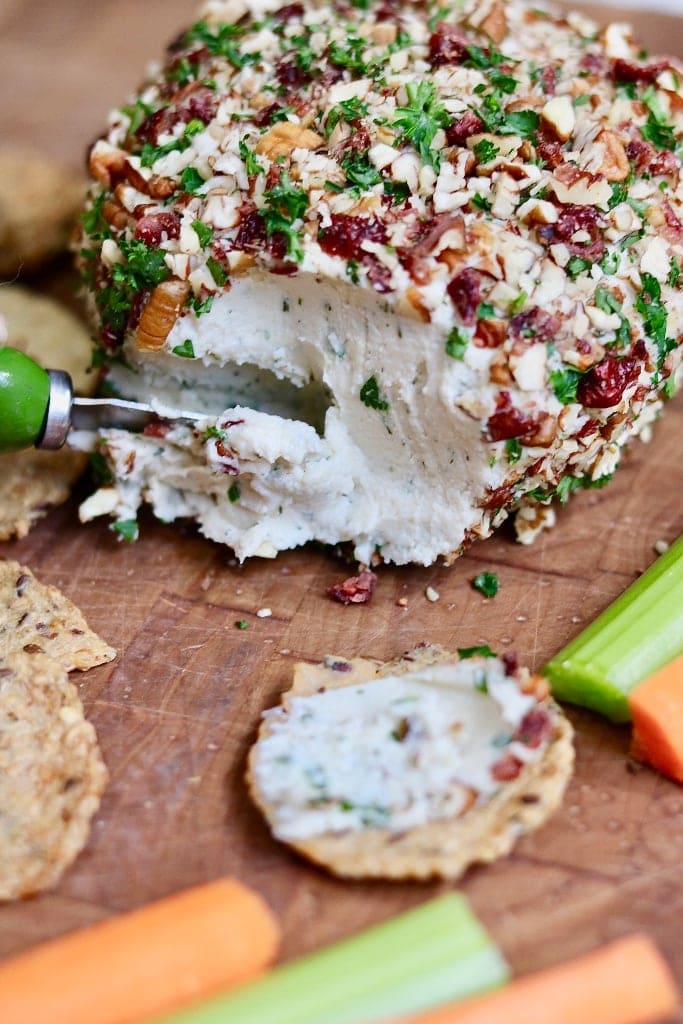 vegan cheese ball being sliced with a knife