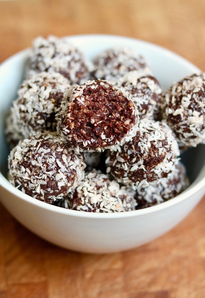 chocolate coconut date balls in a white bowl