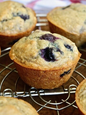 vegan blueberry muffins on a cooling rack