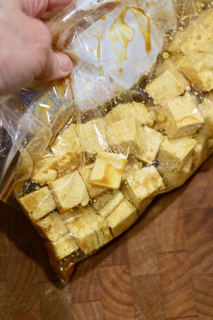 cubed tofu marinating in a freezer bag