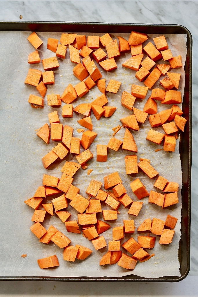chopped sweet potatoes on baking sheet 