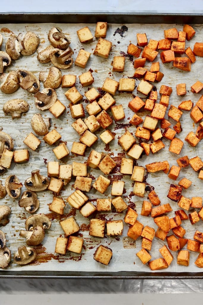 roasted sweet potatoes tofu and mushrooms on a baking sheet