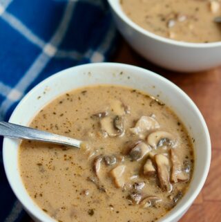 a bowl of cream of mushroom soup with a spoon