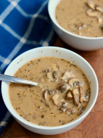 a bowl of cream of mushroom soup with a spoon