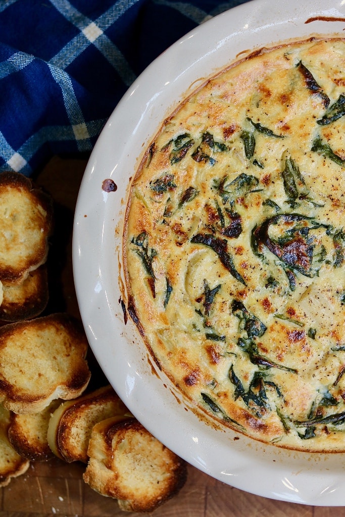 vegan spinach artichoke dip baked in an oven proof dish