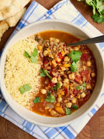 moroccan stew in a white bowl with couscous