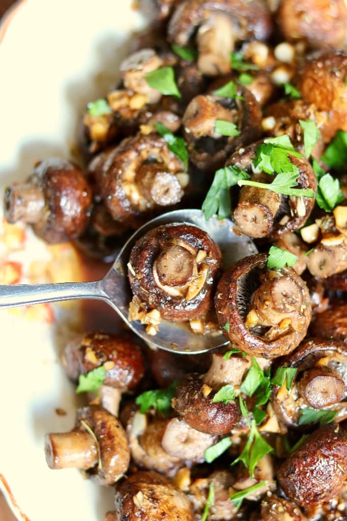 close up of roasted mushrooms in a serving dish 