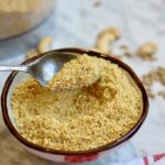 vegan parmesan cheese in a bowl with a spoon