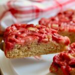 slice of strawberry rhubarb cake on a serving pie spatula