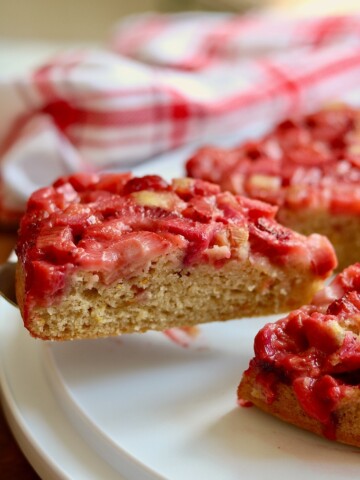 slice of strawberry rhubarb cake on a serving pie spatula