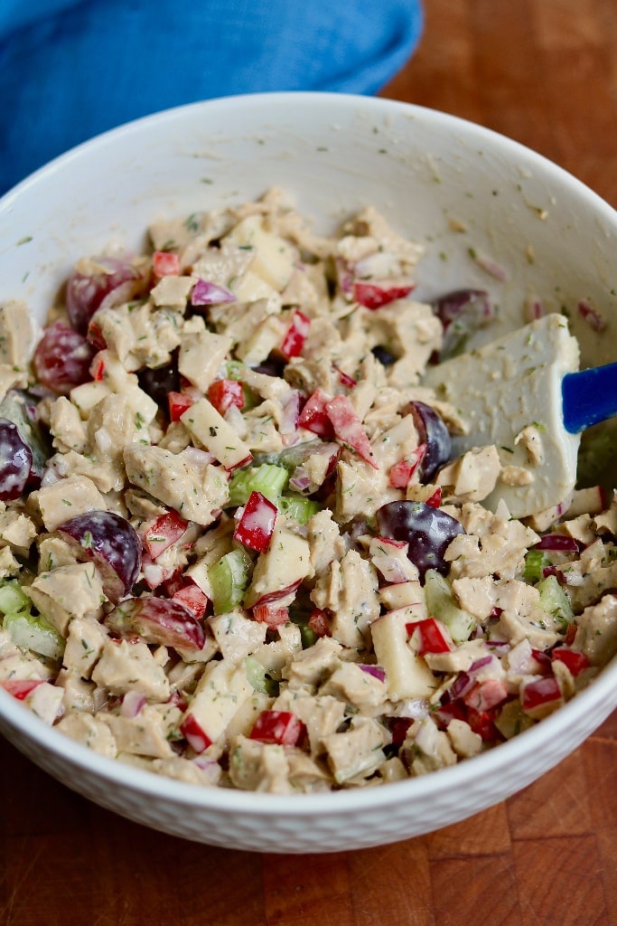 vegan chicken salad in a large bowl with a spatula